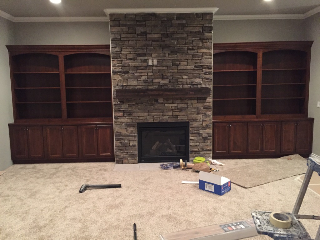 Handcrafted Solid Hardwood Arched Built-In Bookcases Flanking Stone Fireplace