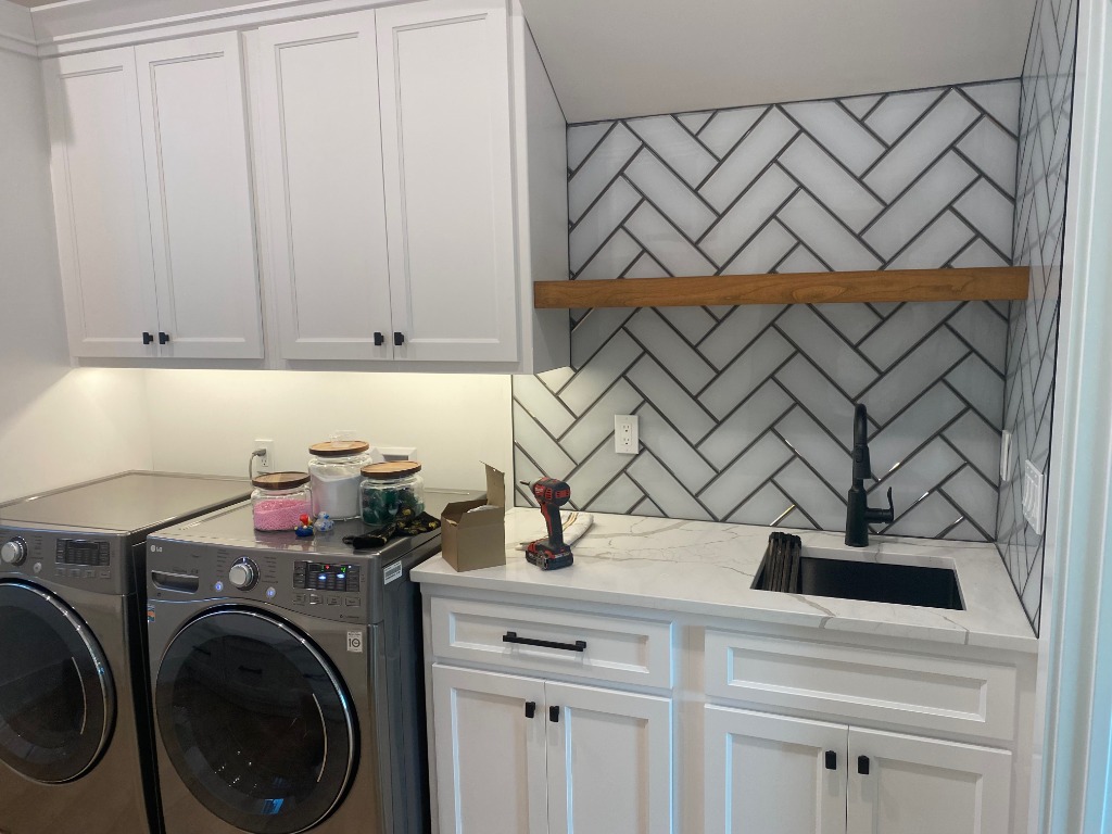 Custom Laundry Room Suite with Under-Cabinet Lighting and Herringbone Tile