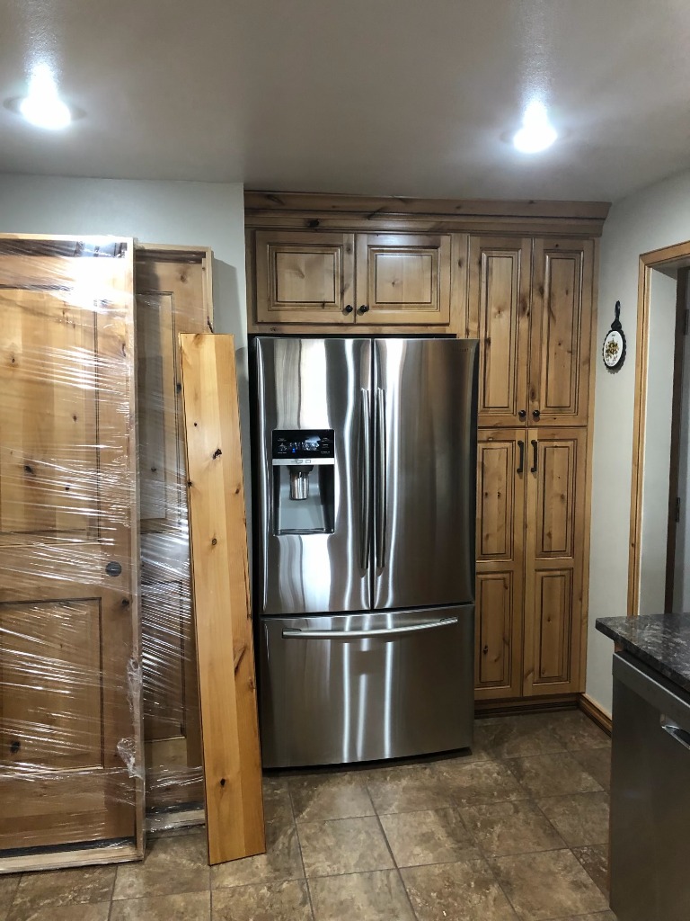 Custom Knotty Alder Refrigerator Enclosure and Full-Height Pantry Cabinetry